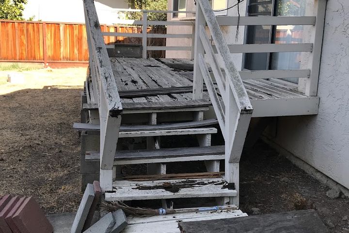 Weathered exterior deck stairs before renovation