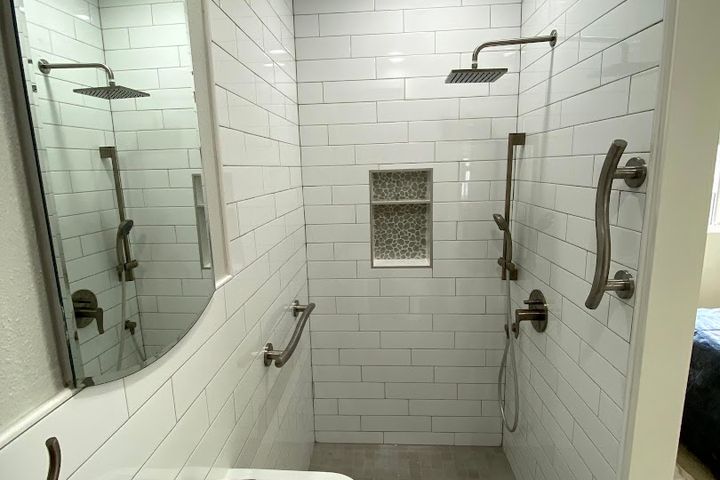 Walk-in shower with white subway tile, glass enclosure, and rain showerhead