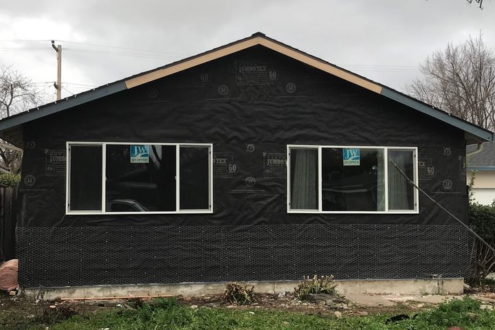 Renovated home exterior prepared for final siding
